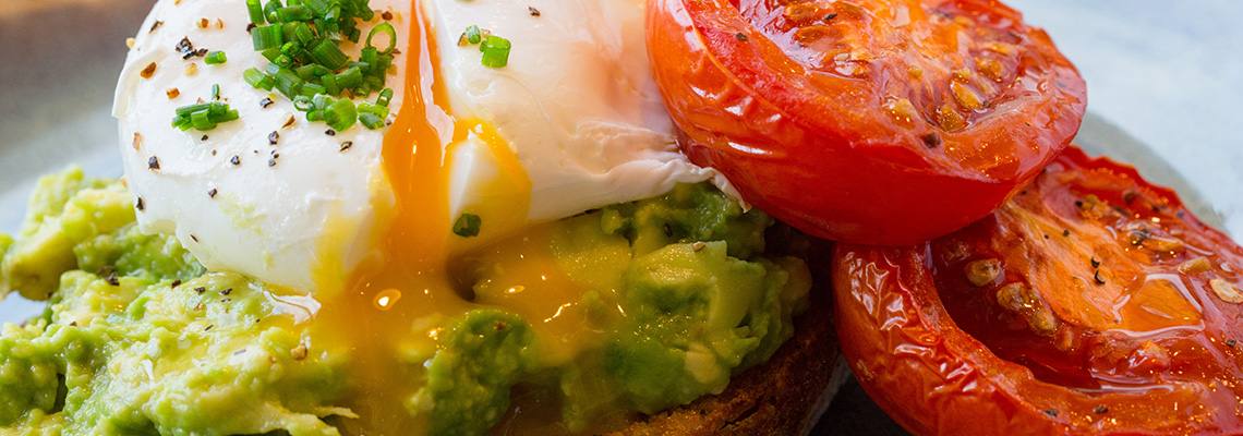 Poached egg, smashed avocado and slow-roast tomatoes on sourdough.